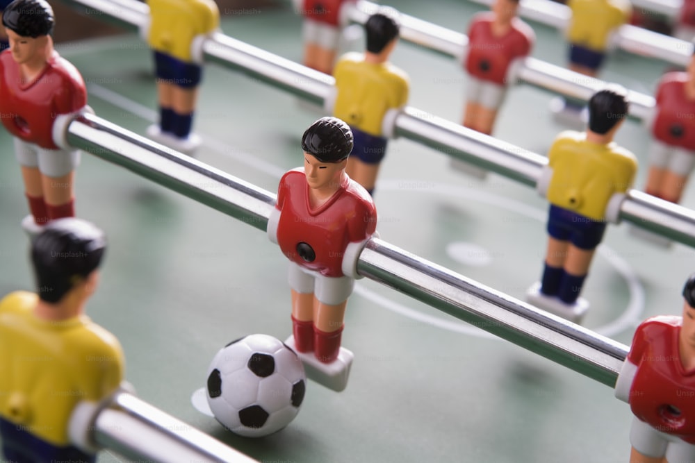 a close up of a foosball with a soccer ball