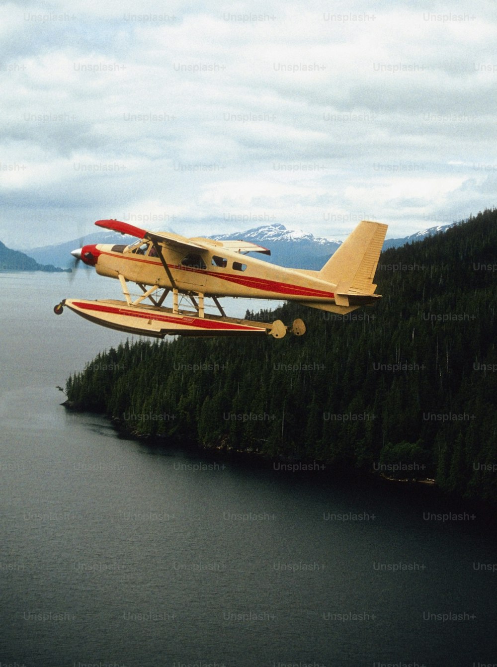 a small plane flying over a large body of water