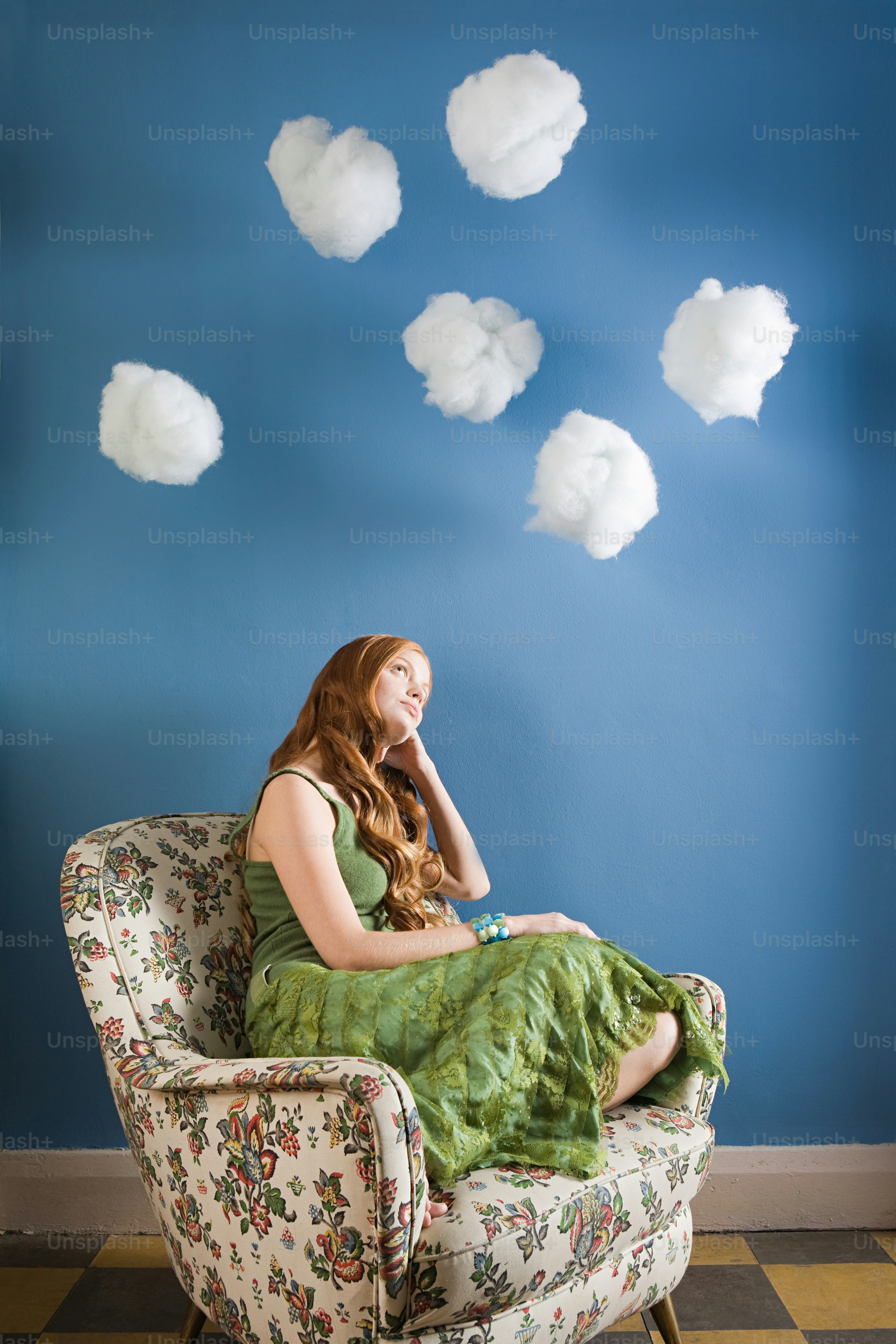 A woman in a green dress sitting on a chair photo – Cloud - sky Image ...