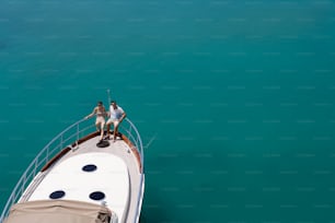 two people sitting on the bow of a boat