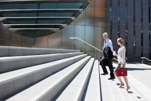 a man and a woman walking down a flight of stairs