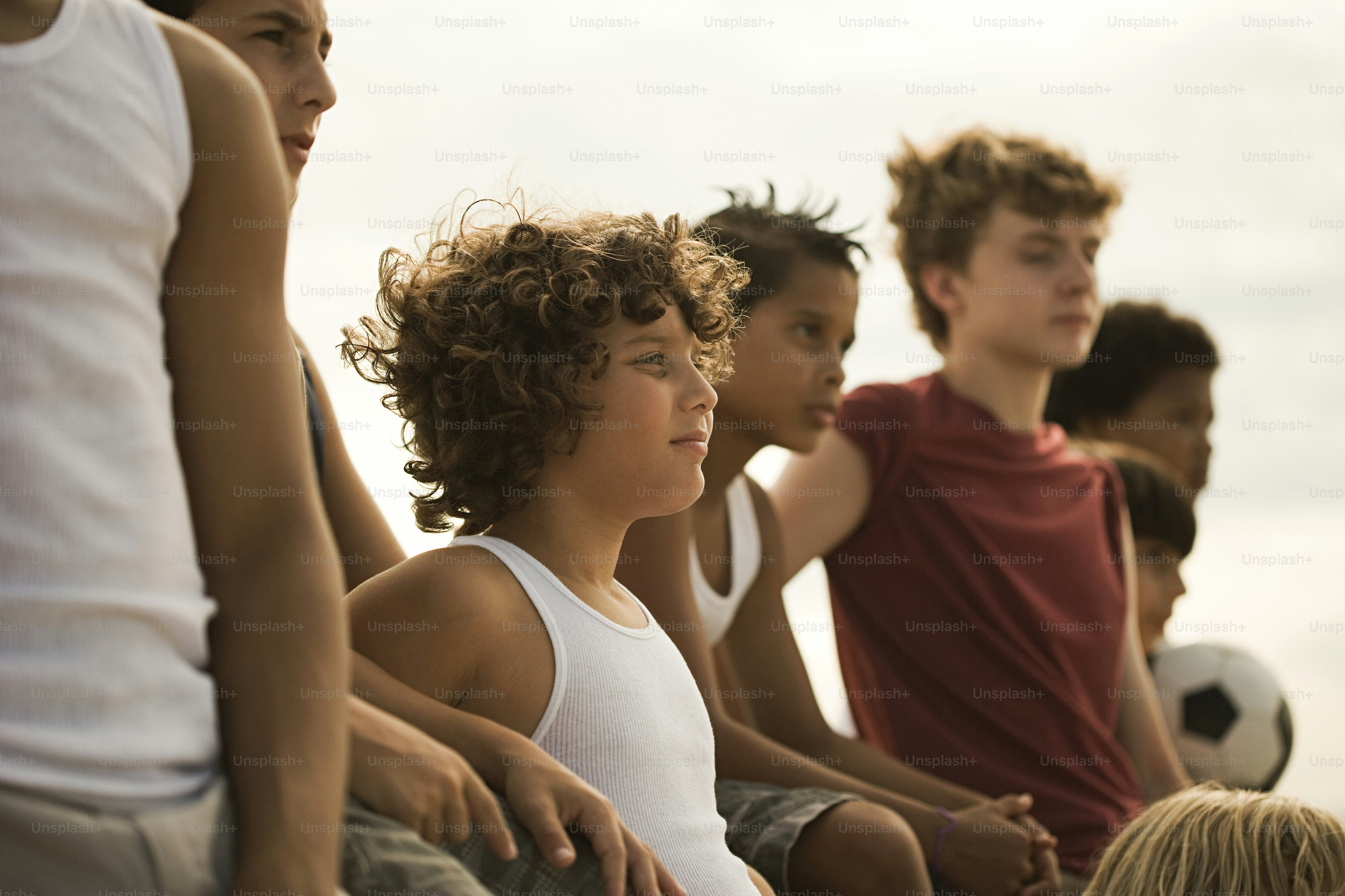 a group of young boys sitting next to each other