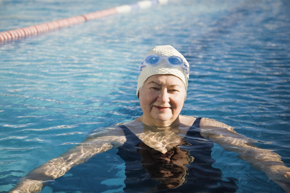 a woman swimming in a pool with goggles on