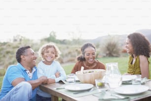 a group of people sitting around a wooden table