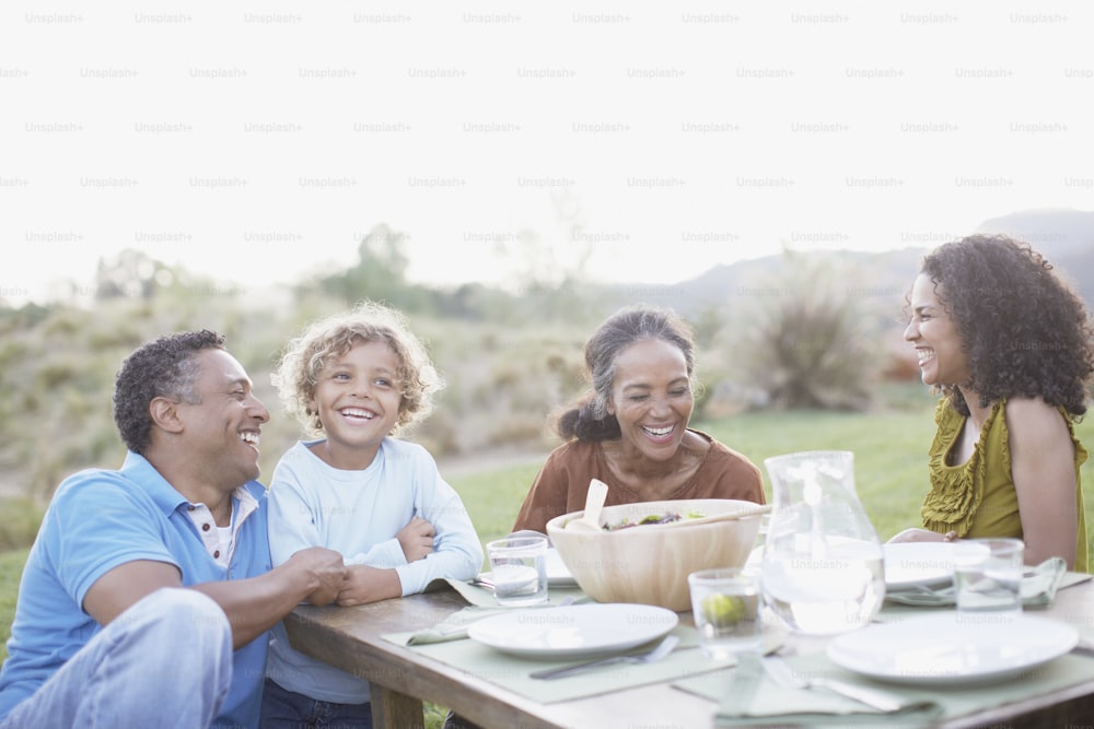 a group of people sitting around a wooden table