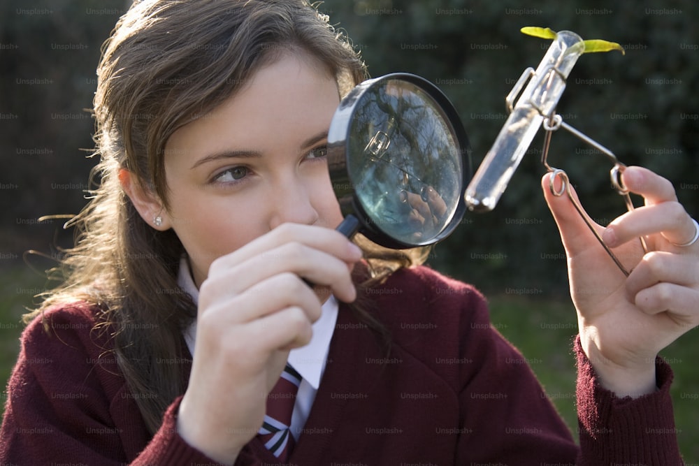 a girl looking through a magnifying glass