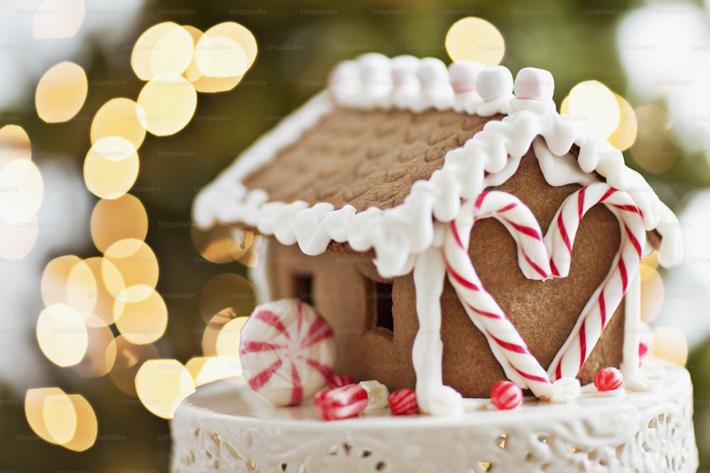 a close up of a gingerbread house with candy canes