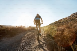 Mountain biker riding on single track trail in the countryside