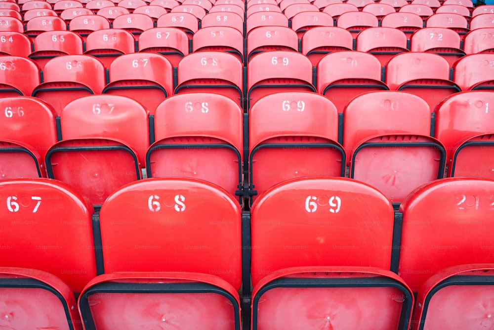rows of red seats with numbers on them