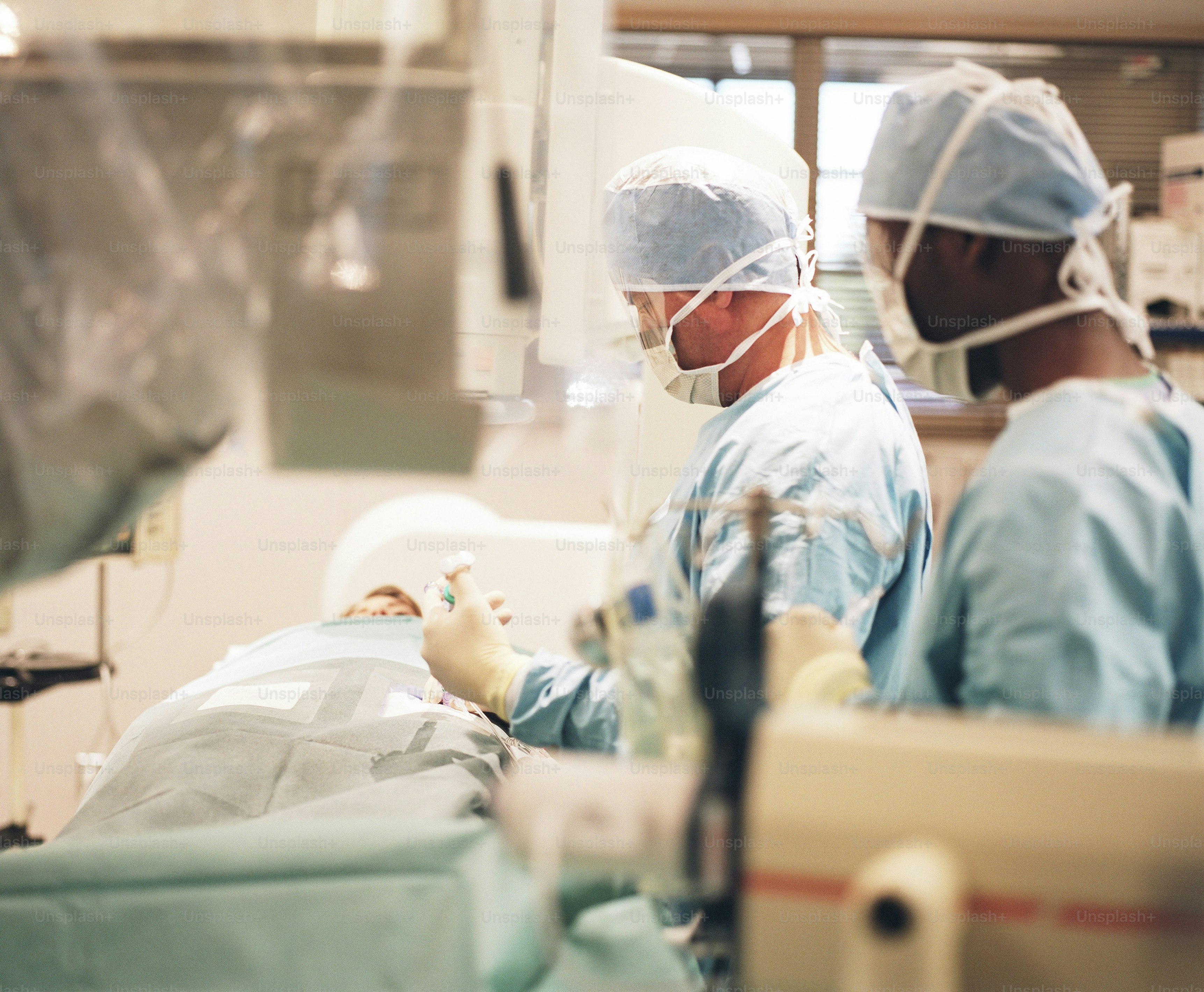 a couple of people in a hospital room