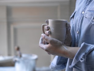 a woman holding a coffee cup in her hands