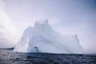 a large iceberg floating in the middle of the ocean