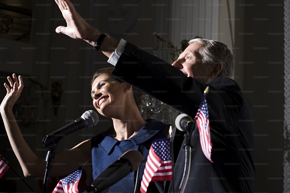 a man and a woman standing in front of a microphone