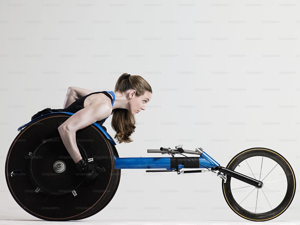 a woman in a black tank top riding a blue bike