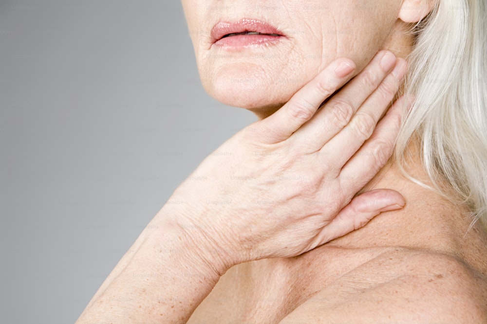 a woman holding her neck in pain