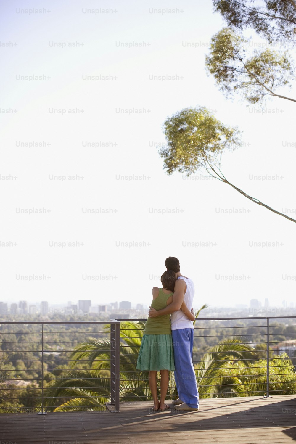 a man and a woman embracing on a deck