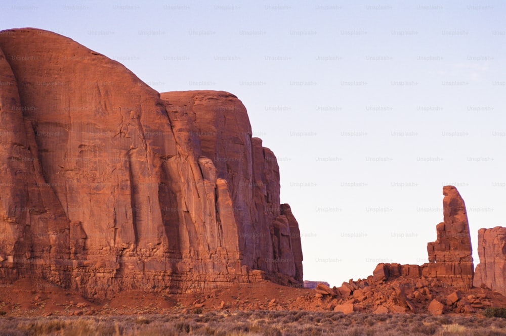 a large rock formation in the middle of a desert