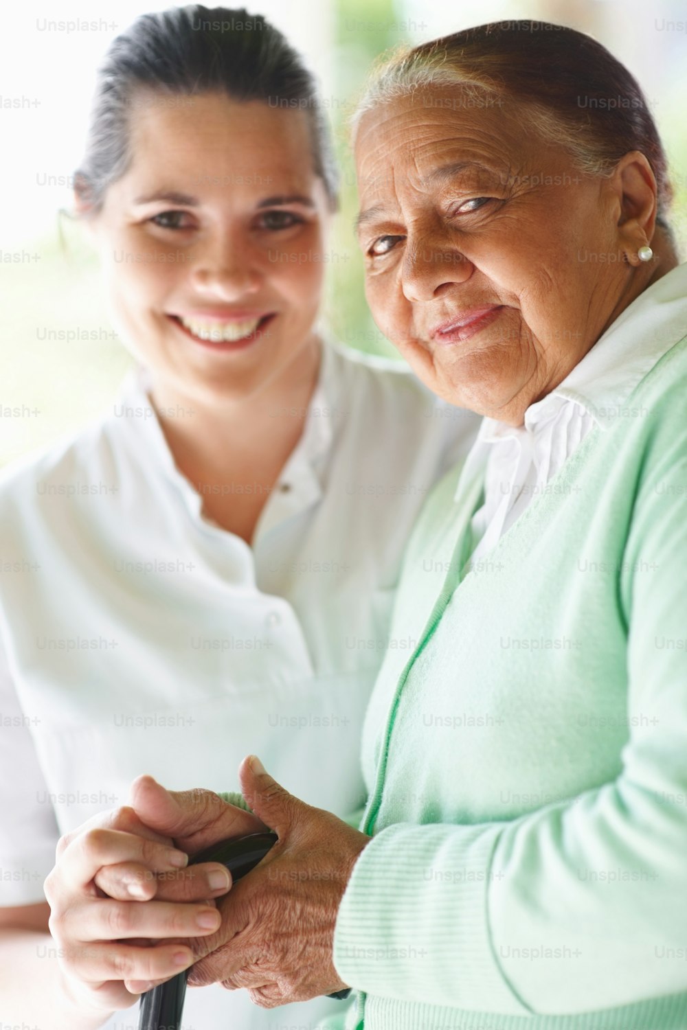 Elderly woman smiling with a nurse