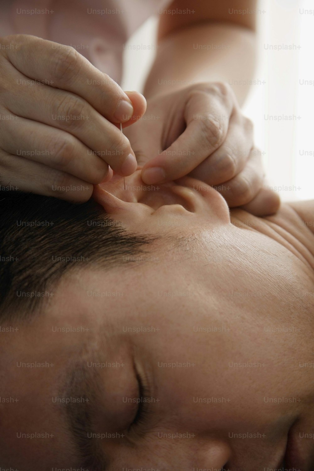 a man getting a head massage from a woman