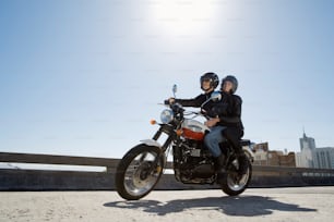 two people on a motorcycle on a bridge