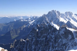 a mountain range with snow covered mountains in the background