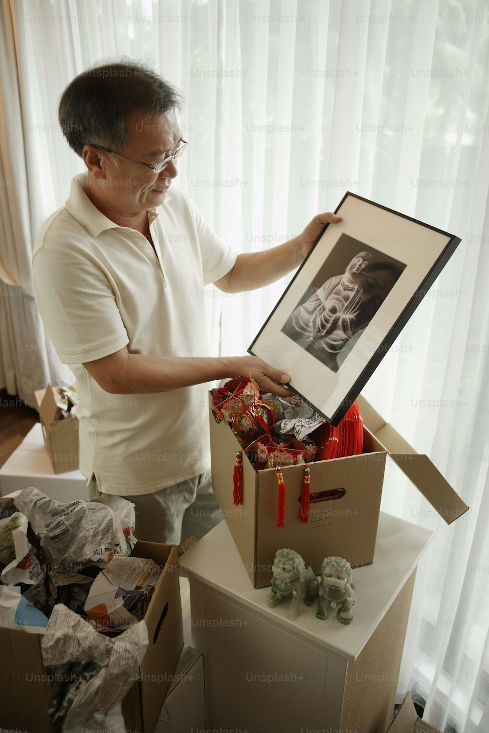 a man holding a box with a picture inside of it