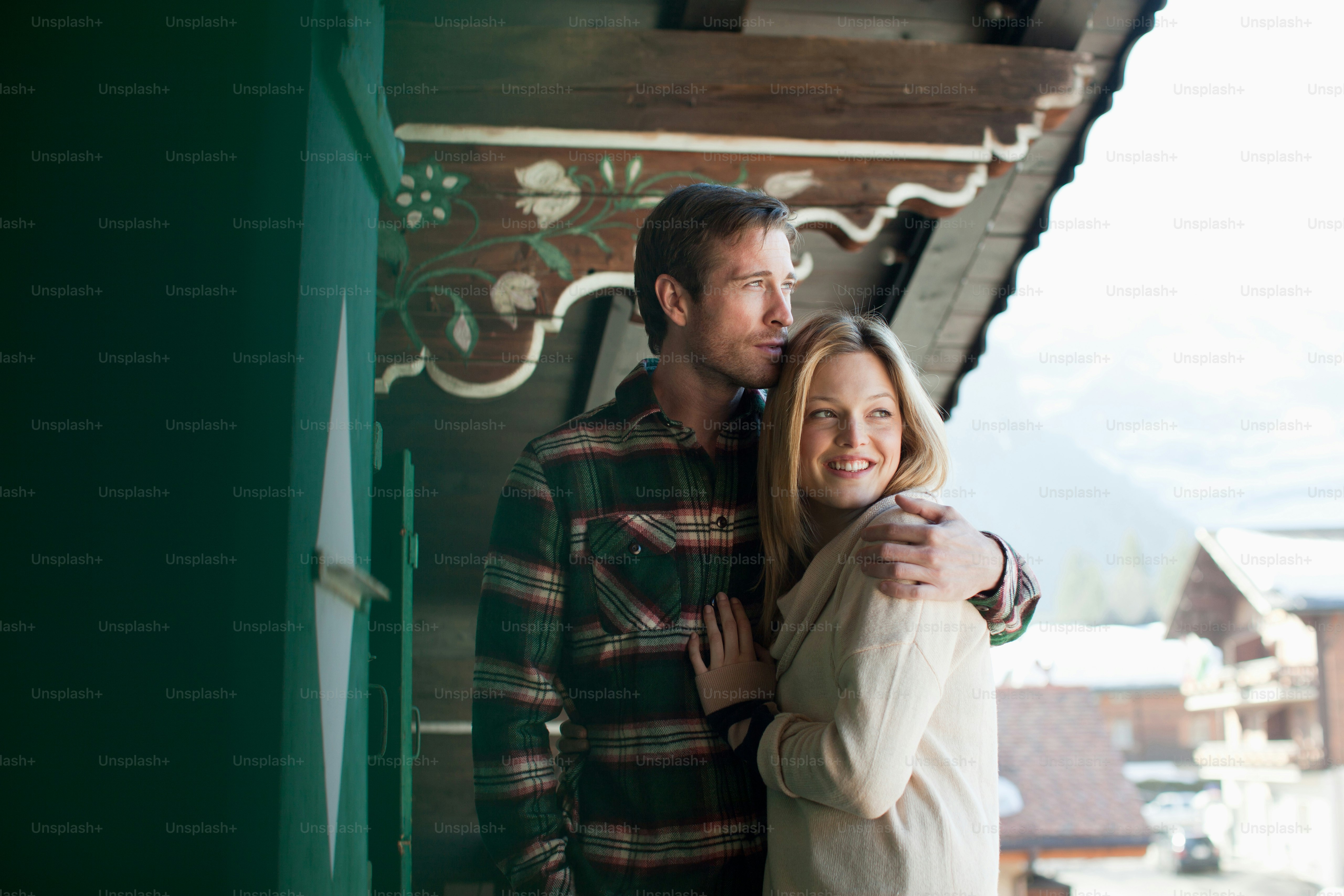 A man and a woman standing next to each other photo – Log cabin Image ...