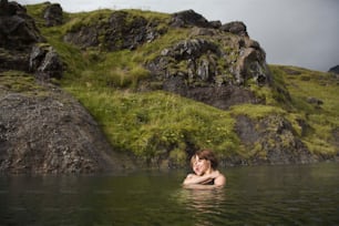 a woman swimming in a body of water