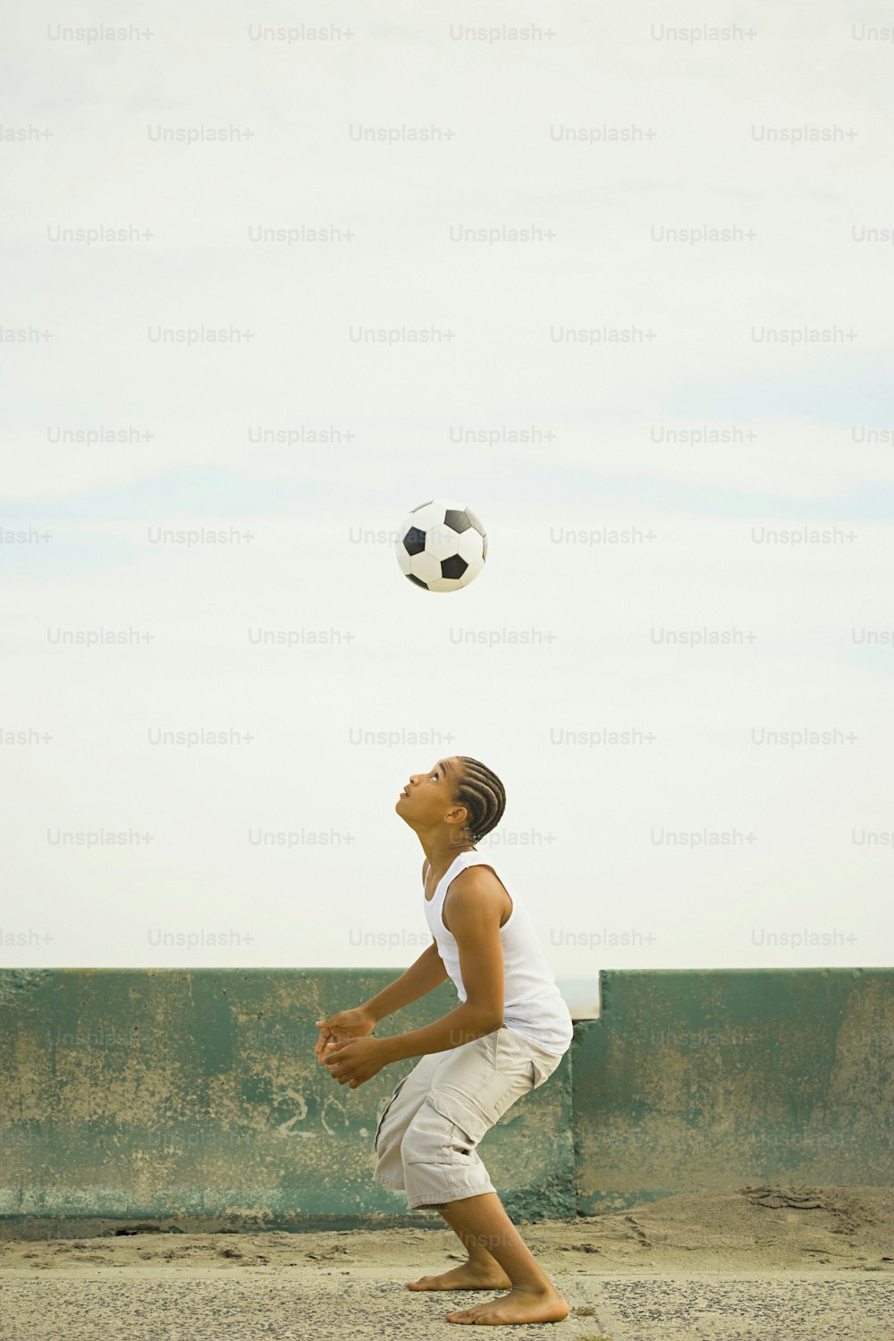 a man is playing with a soccer ball