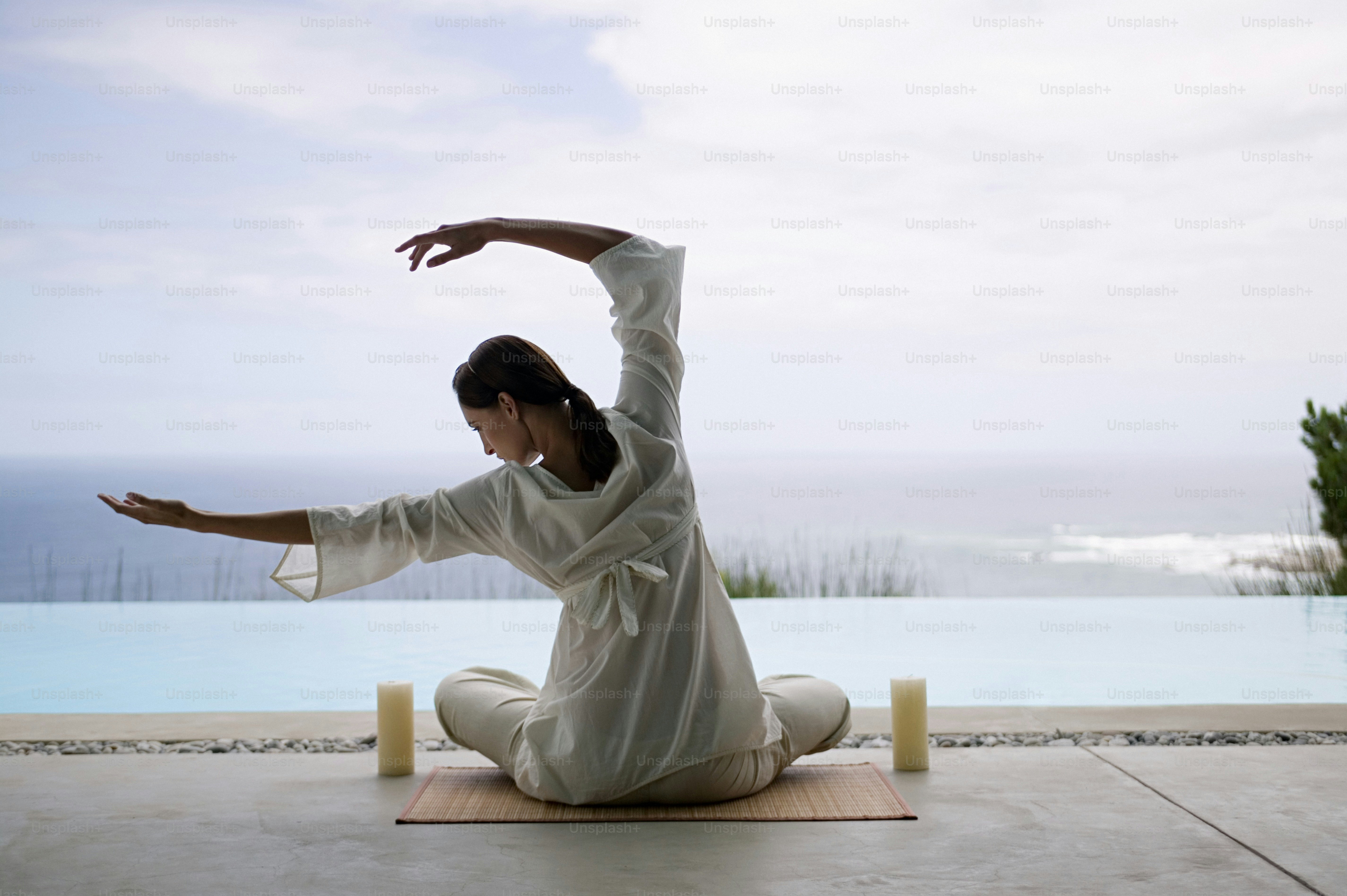 A woman in a white outfit doing a yoga pose photo – Yoga Image on Unsplash
