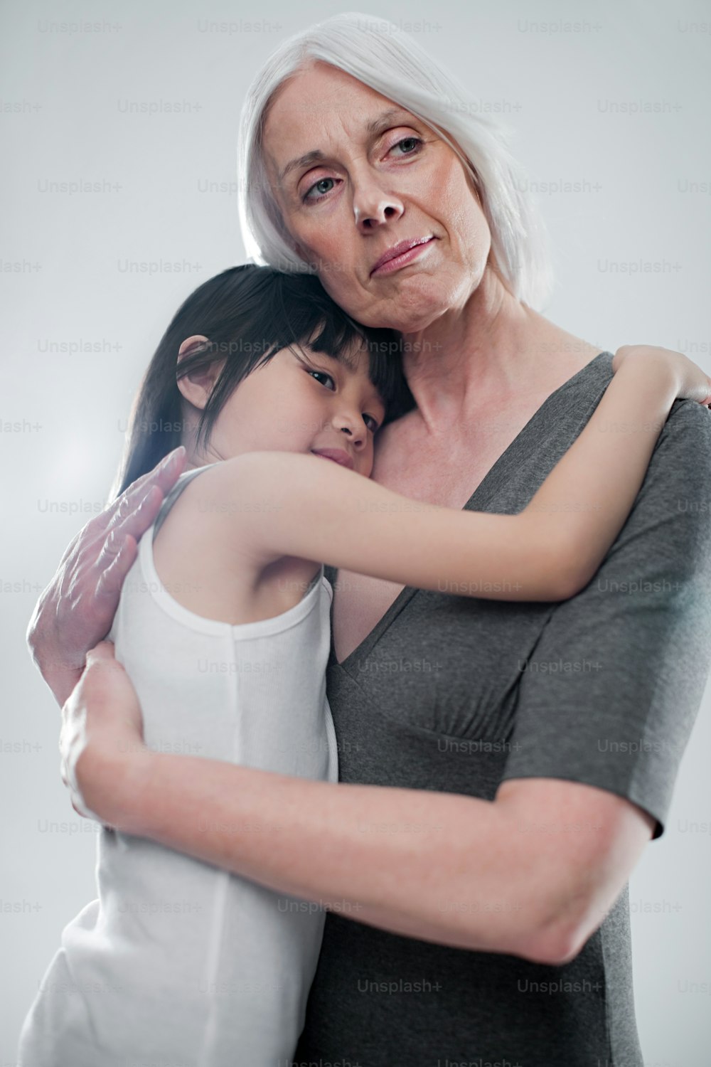 an older woman hugging a young girl