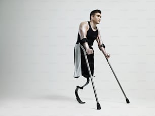 a man with crutches is holding a cane