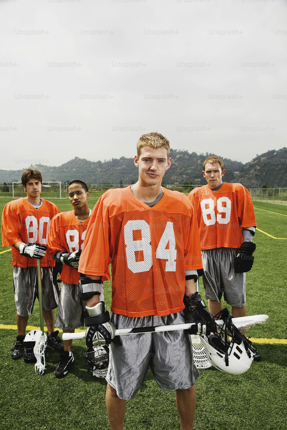 a group of young men standing next to each other on a field