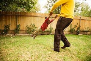 a man and a child playing in a yard