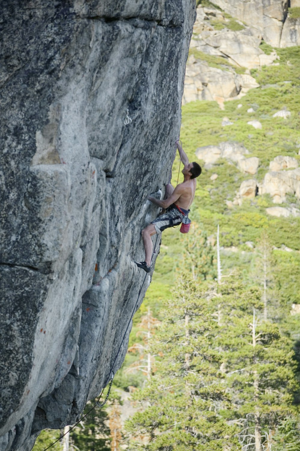 a man climbing up the side of a mountain