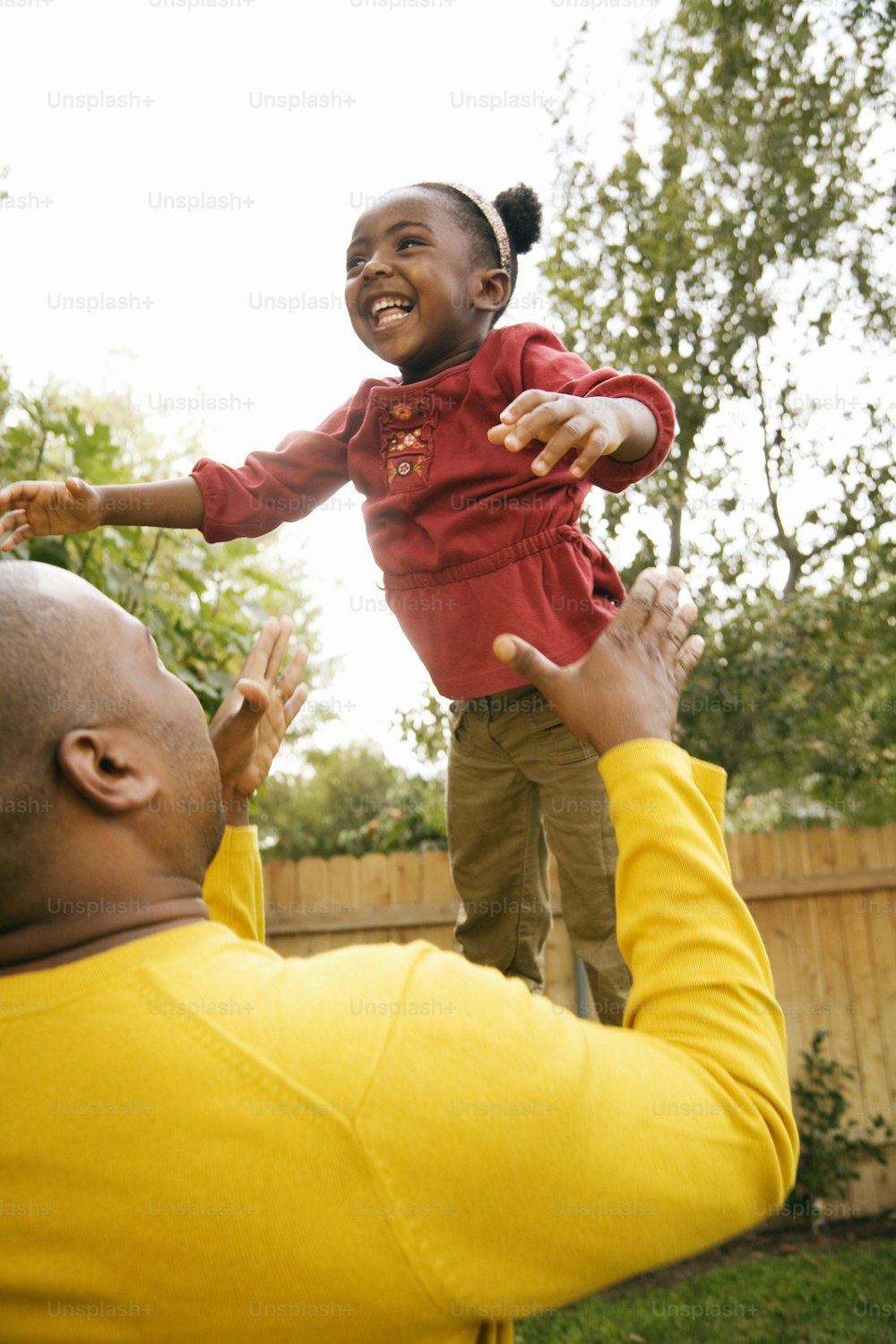 a man holding a child up in the air