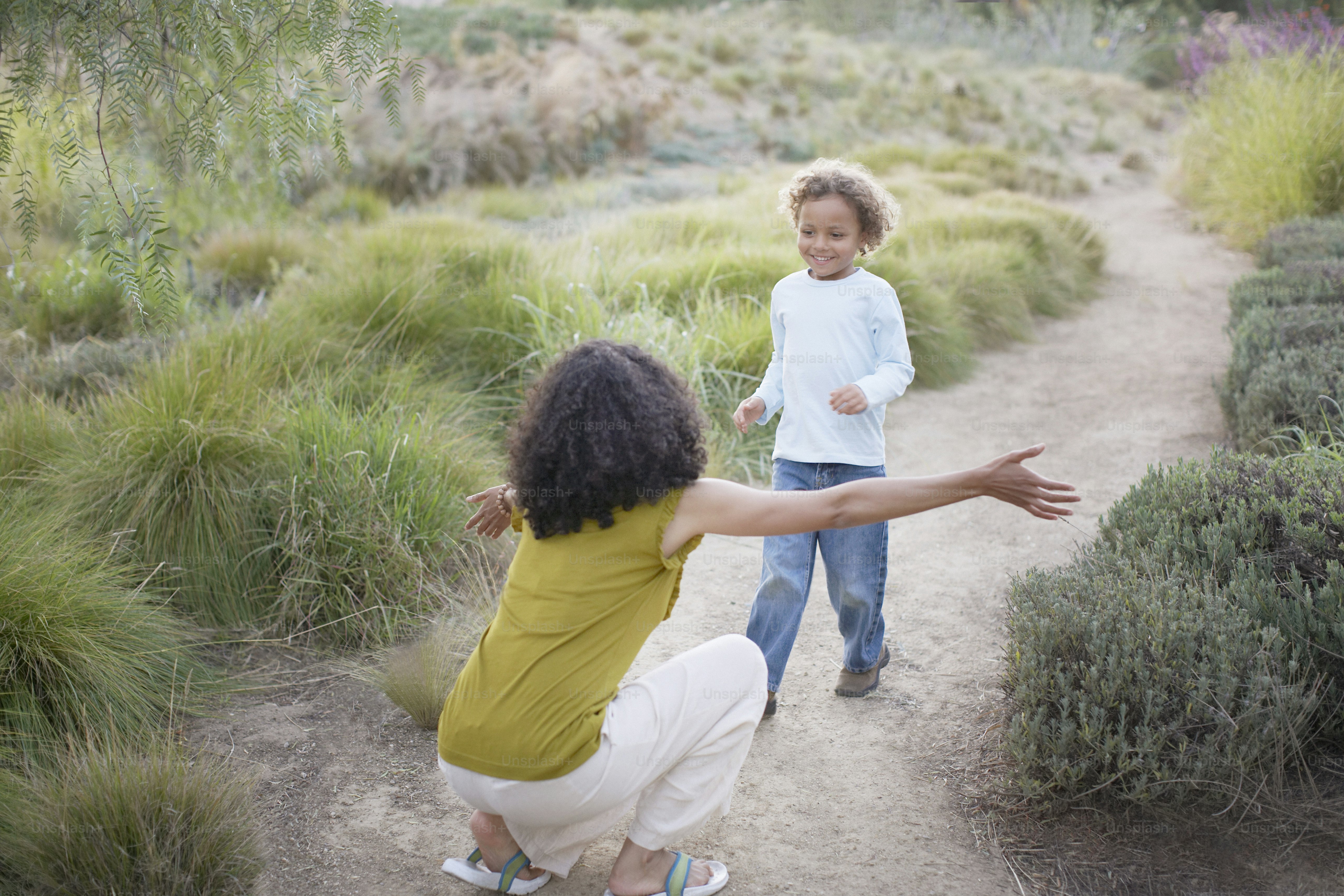 a woman and a child playing with a frisbee