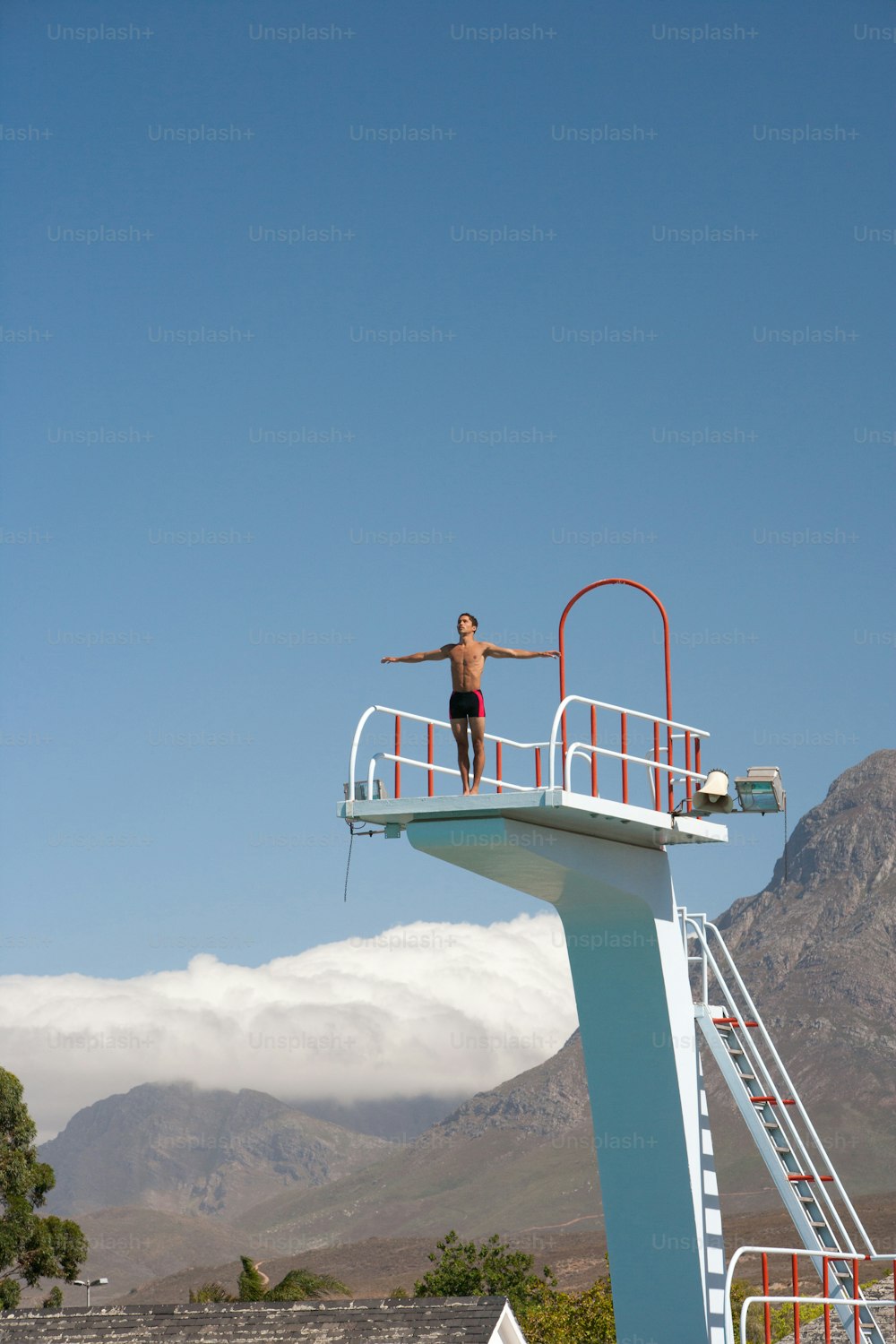 a man is standing on a life guard tower