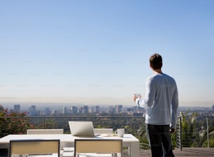 a man standing at a table with a laptop on it