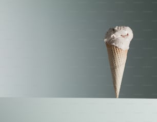 an ice cream cone with a single scoop of ice cream