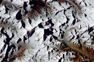 an aerial view of a snow covered mountain range