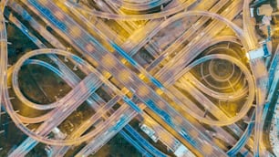 Aerial view highway road intersection at dusk for transportation, distribution or traffic background.