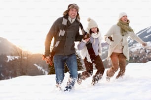 a group of people walking through the snow