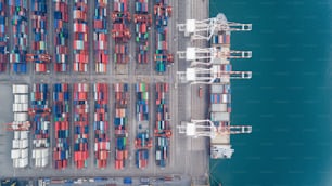 Aerial view sea port warehouse and container ship or crane ship working for delivery containers shipment. Suitable use for transport or import export to global logistics concept.