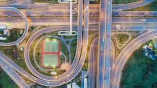 Aerial view highway road intersection and circle at dusk for transportation, distribution or traffic background.