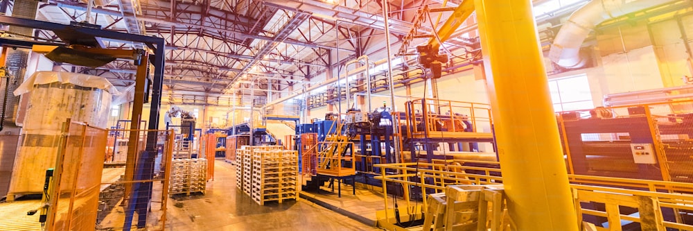 Modern operational plant with stocks of pallets heavy industry machinery metalworking workshop concept.
