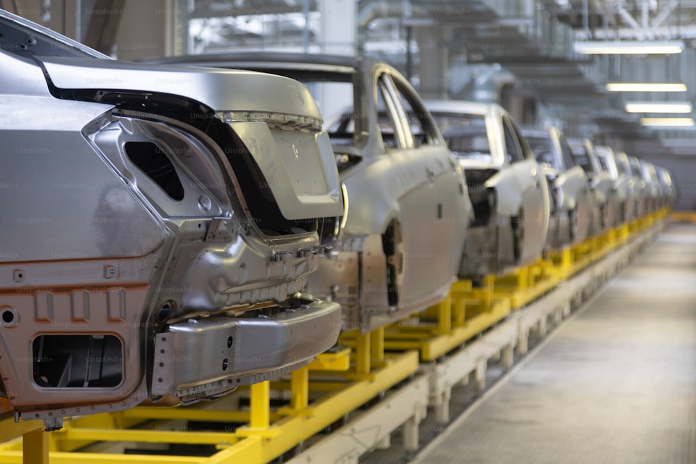 body of car on conveyor Modern Assembly of cars at plant. automated build process of car body.