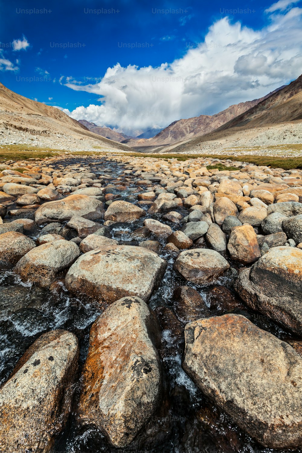 Arroyo de montaña con piedras en el Himalaya cerca del paso de Khardung La. Ladakh, Jammu y Cachemira, India
