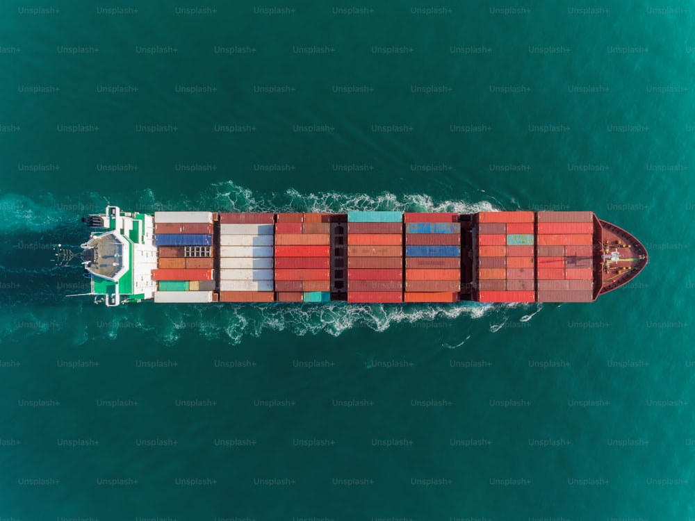 Aerial top view container ship full load container top speed for logistics import export, shipping or transportation.
