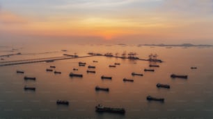 Aerial view Oil ship tanker park on the sea at dusk for transportation crude oil from refinery.